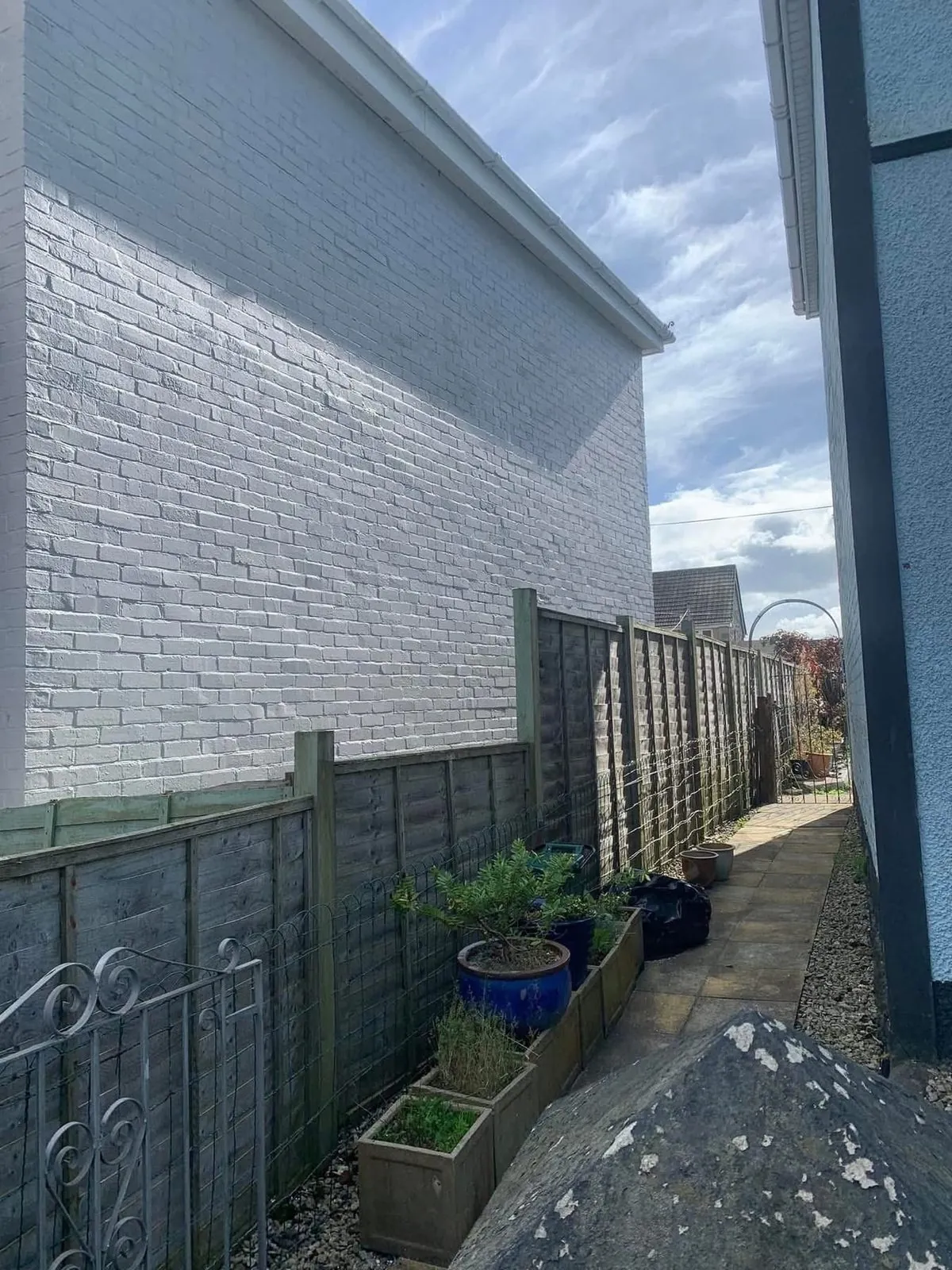 Freshly painted brick wall after preparation and masonry paint in Torquay